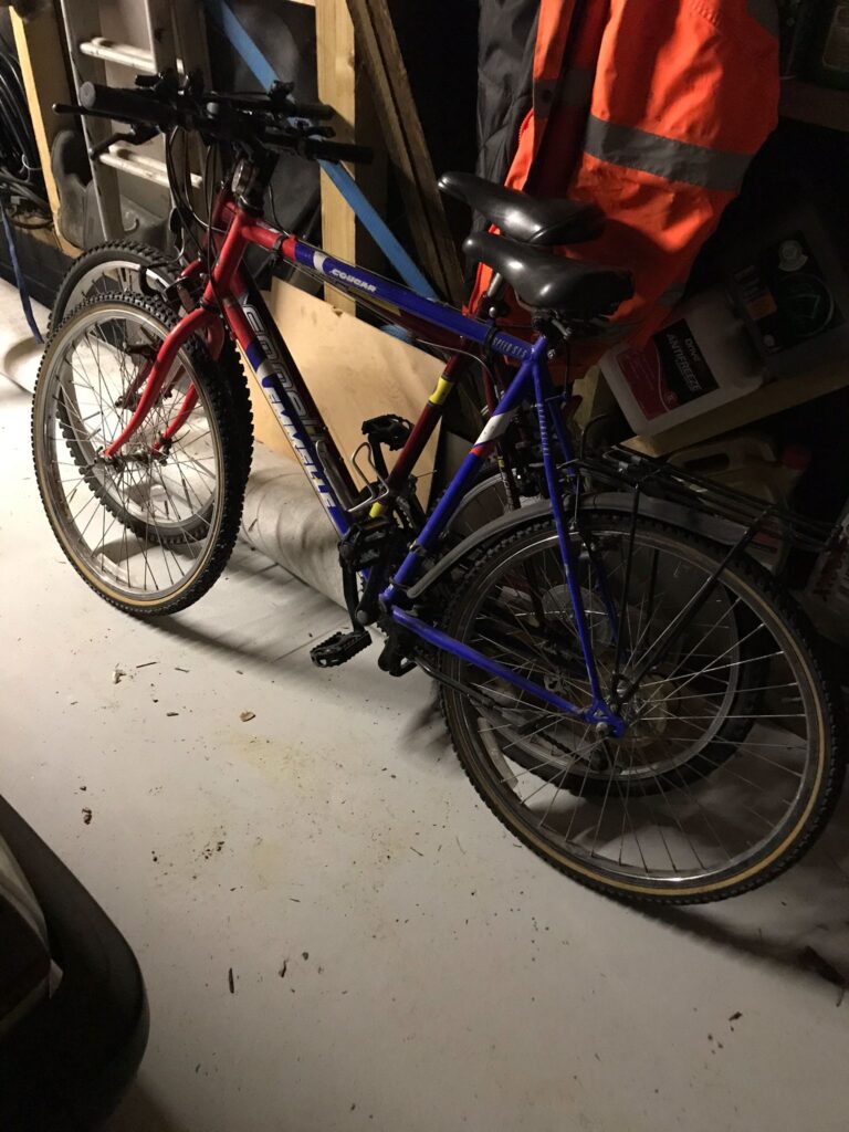 Two old bikes in a garage